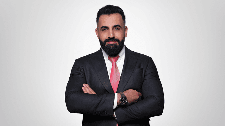 "Bashar Amin, founder of Gradezilla, stands confidently in a business suit, embodying leadership and expertise in digital marketing education."