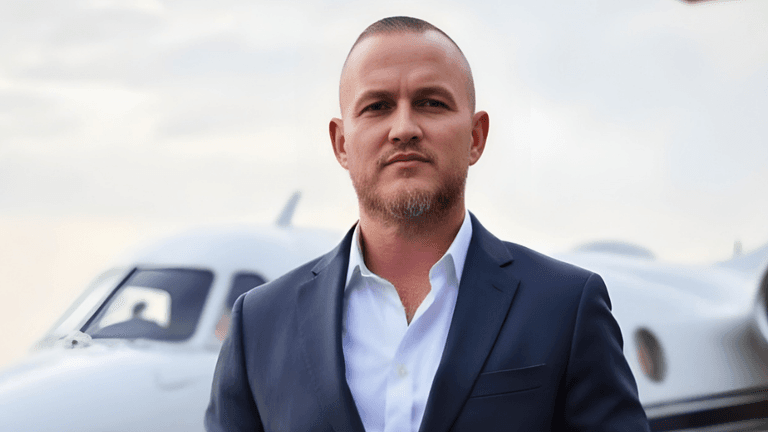 Bryan Wood, founder of Intel2Instagram, standing confidently in front of a private jet, embodying his approach to building authority through strategic social media