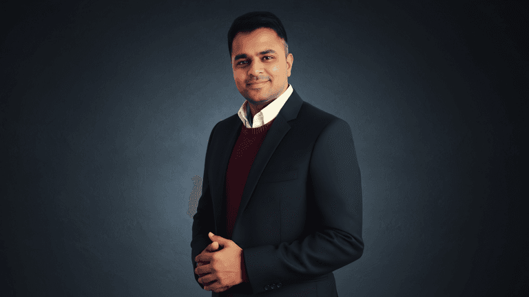 “Professional leader in formal business attire posing confidently in a studio setting, representing strong engineering leadership, innovation, reliability, and modern FinTech excellence.”