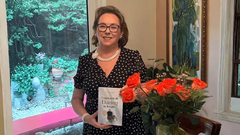 "Petronely Grindea, bestselling author and wellness innovator, holding her memoir 'Unapologetically Daring to Inspire' while promoting women’s empowerment and inner strength."