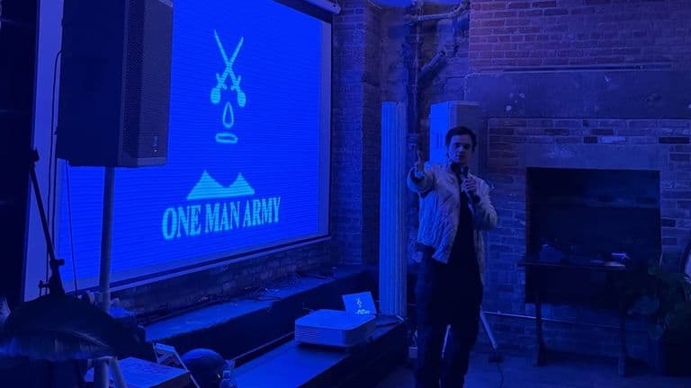 **Aaron Dalla Villa presenting One Man Army’s studio vision at a live screening and industry event.**