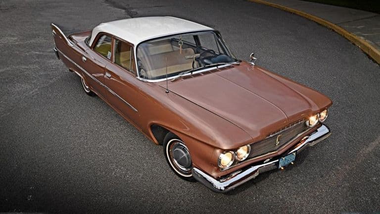 A classic 1960 Plymouth Savoy with a vintage two-tone design, capturing the essence of American automotive history and style.