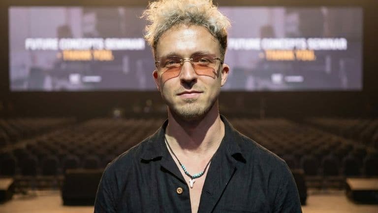 Yasin Borry, founder of BYAS and Vibe Agency, stands in front of an audience at a music event.