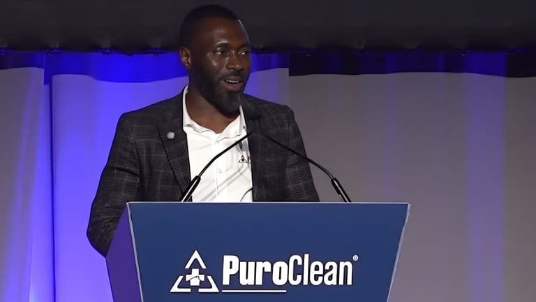 Charles Omajuwa speaks at a PuroClean event, sharing his journey of resilience, leadership, and entrepreneurial success as an immigrant.