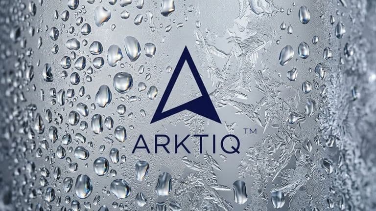 Close-up of the Arktiq Vodka logo on a frosted, condensation-covered surface emphasizing ice-cold purity.