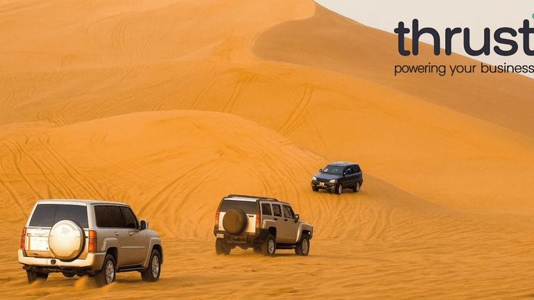 (Desert with cars): Off-road vehicles navigating Dubai’s desert, symbolizing business freedom in a tax-efficient environment.