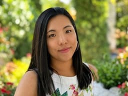 Portrait of HI Connect+ founder Zoe Lau Gungor outdoors in a garden setting.