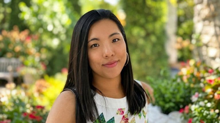 Portrait of HI Connect+ founder Zoe Lau Gungor outdoors in a garden setting.