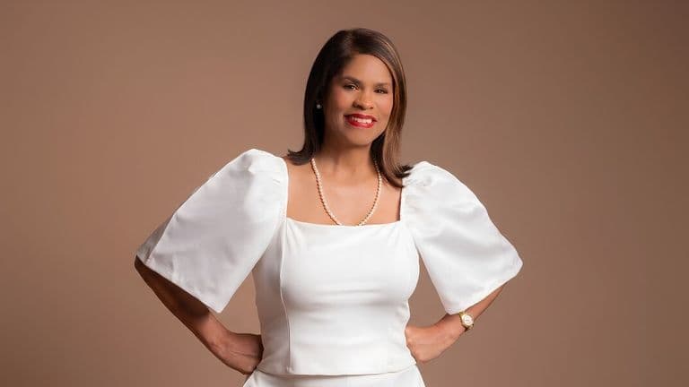 CeWyon Chandler-Ward posing in white outfit against neutral background promoting entrepreneurship, publishing, and women’s leadership.