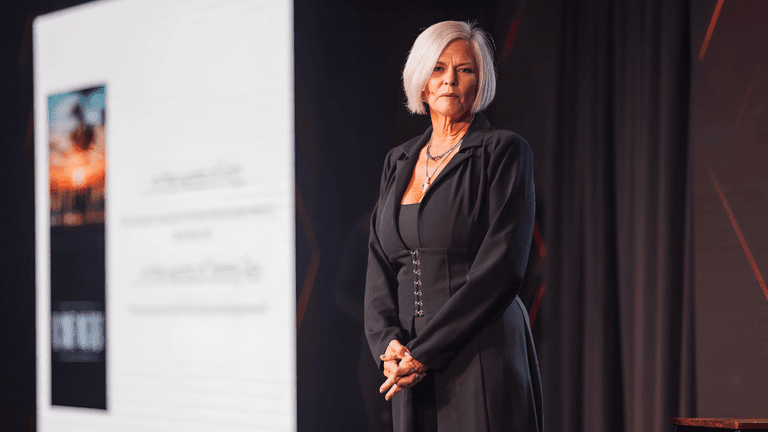 Melissa von Musser speaking on stage about transformational leadership, healing trauma, and reclaiming personal power.