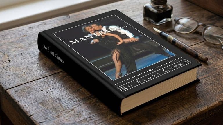 A hardcover book titled "Man Leads" by Ro Élori Cutno on a wooden table. The cover shows a couple dancing elegantly. Nearby are glasses and a pen, suggesting a cozy reading atmosphere.