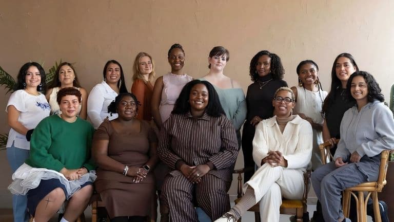 A diverse group of women from Boboto Doula Care, offering culturally sensitive postpartum support, gathered for a team photo.