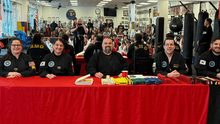 "Martial arts event judges with Grandmaster Konrad Spillmann at Global Martial Arts USA, celebrating excellence and leadership."
