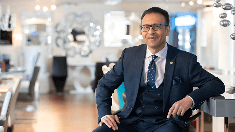 Asad Shamim, CEO of Furniture in Fashion, showcasing modern, affordable furniture in a stylish, customer-focused showroom environment.