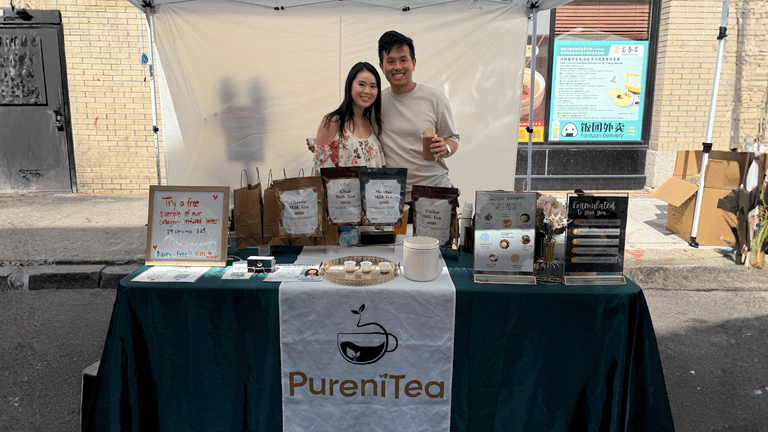 Brenda Yik and her partner at PureniTea booth, showcasing their wellness-focused milk tea blends at a local event.