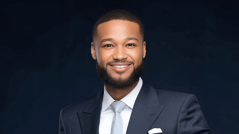 Demetrius McCloud, founder of The McCloud Firm, dressed in a sharp suit, smiling confidently. He embodies the firm's "Legal Sniper" philosophy, providing precise and client-focused legal services across personal injury, business advisory, and corporate law.