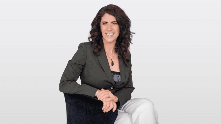 Robbie Spier Miller, founder of Hypnosis Training Canada, seated confidently, representing her role in transforming personal and professional growth.