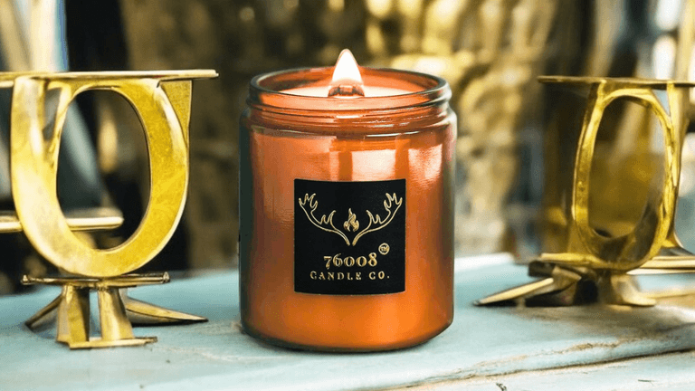 A leather-scented candle from 76008 Candle Co., highlighting the brand's focus on authenticity, craftsmanship, and family legacy.
