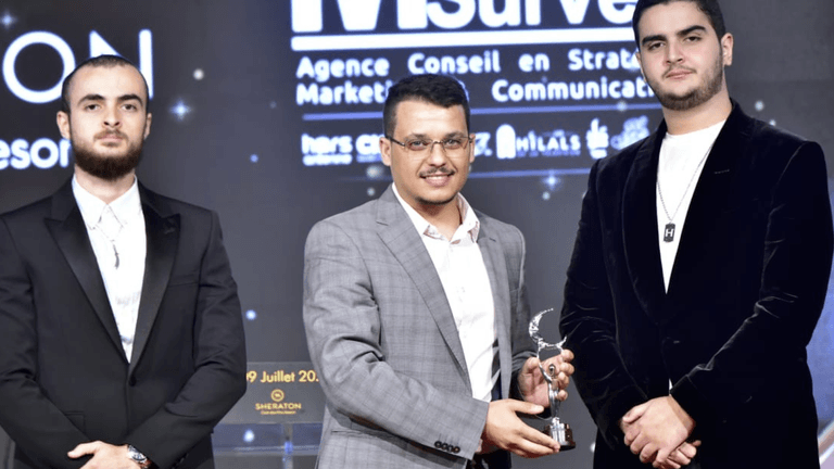 Seif Sid Ali Maloufi and team receiving an award, highlighting Ascend Studios' success in AI automation and business transformation.