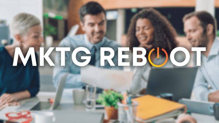 A diverse group of professionals collaborates around a table, discussing strategies to optimize marketing efforts, reflecting MKTG Reboot’s focus on structured, growth-driven marketing solutions.