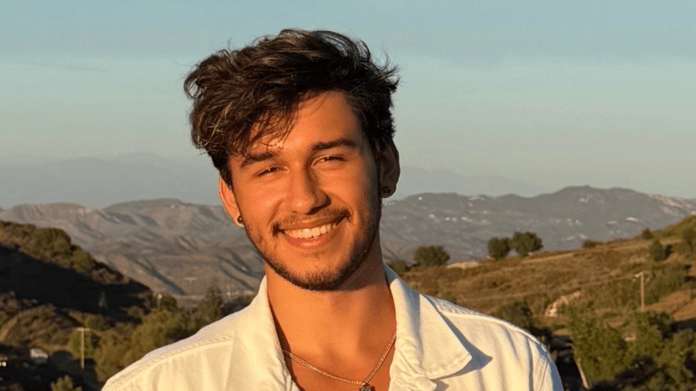 Tim, a multifaceted entertainer from Redondo Beach, California, smiling outdoors with a scenic background. A self-taught musician turned actor, model, and producer, Tim’s diverse talents span across music, film, theater, and fashion, showcasing his versatility and passion for creative expression