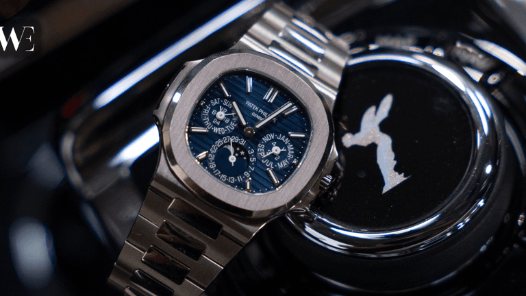Patek Philippe luxury watch displayed beside a Rolls-Royce emblem with the Watches Established logo.