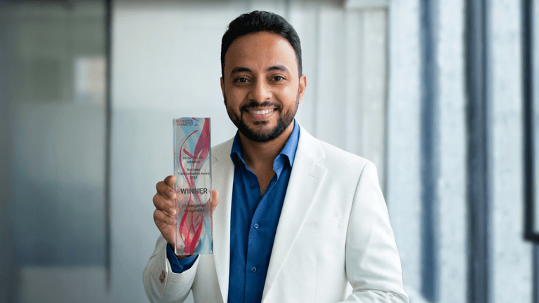 Mostafa Shaban, founder of XLR8 WELLNESS, holding the Business Transformation Award, highlighting leadership in longevity and wellness innovation.