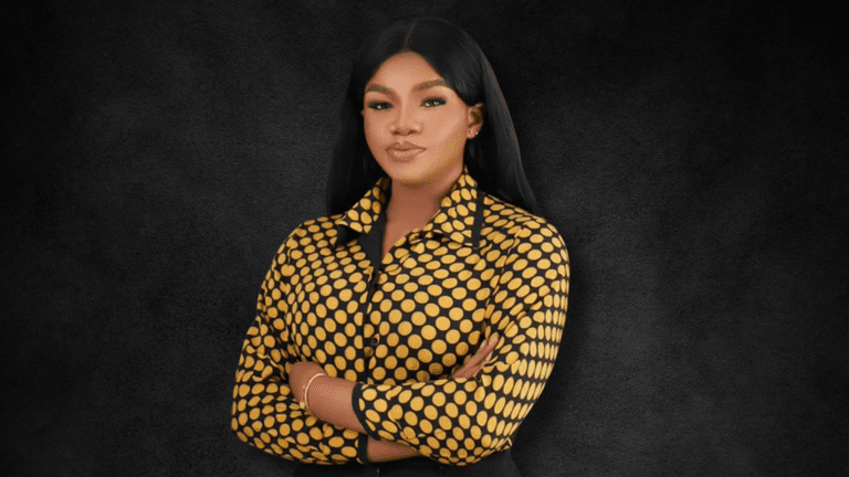 "Portrait of a confident woman in a bold polka dot shirt, standing with arms crossed against a dark background, exuding strength and professionalism."