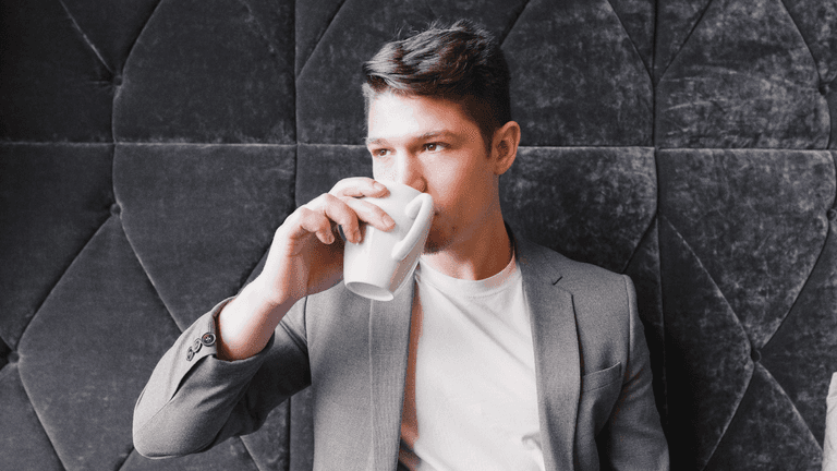 Carey James enjoying a coffee, embodying the essence of personal branding and human connection.