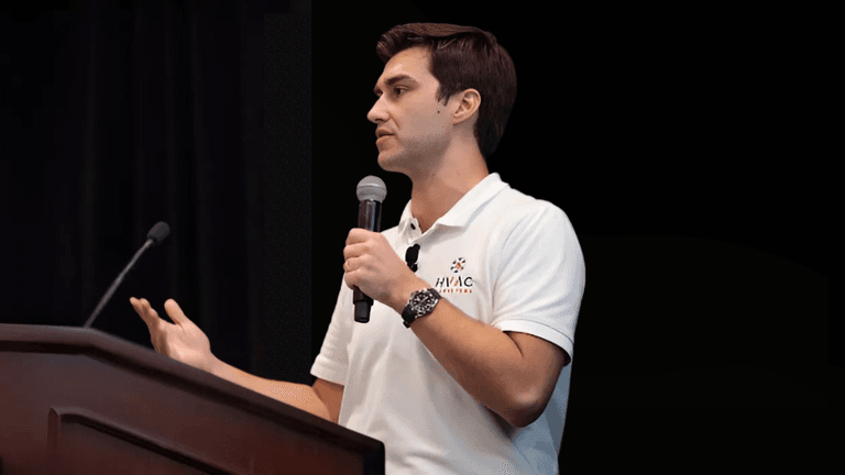 Alex Van Leeuwen speaking at a conference, sharing insights on HVAC marketing strategies and business growth.