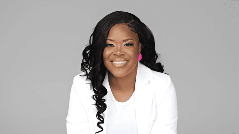 Annika V. Brown, CEO of New Dimension Consulting, smiles confidently after completing her 365-day live-streaming challenge.