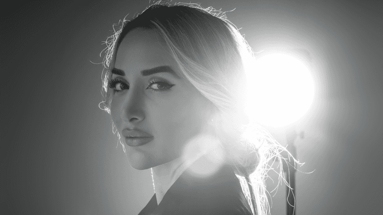 Black and white portrait of a confident woman with long hair, gazing
