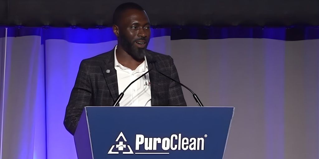 Charles Omajuwa speaks at a PuroClean event, sharing his journey of resilience, leadership, and entrepreneurial success as an immigrant.