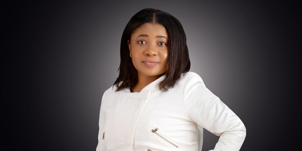 Joy Chukwu, Co-Founder & CTO of Ovaboss, poses in a white jacket, symbolizing innovation and leadership in e-commerce.