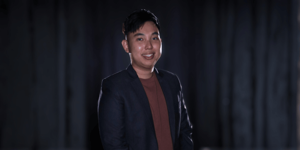 Chan Ming Yang, founder of M&A Education, standing confidently in a professional setting.