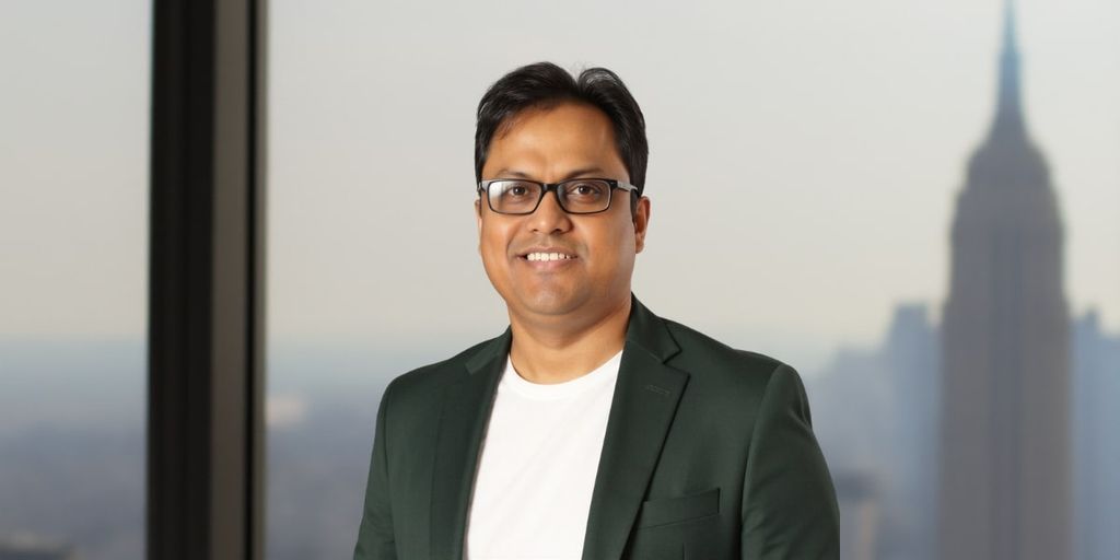 Dr. Srikumar Nayak, a pioneer in AI for financial crime prevention, standing in front of a city skyline.