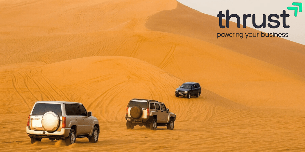 (Desert with cars): Off-road vehicles navigating Dubai’s desert, symbolizing business freedom in a tax-efficient environment.