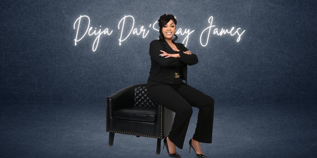 Deija Dar’Shay James seated in black business attire before a branded backdrop, representing entrepreneurship and business leadership.