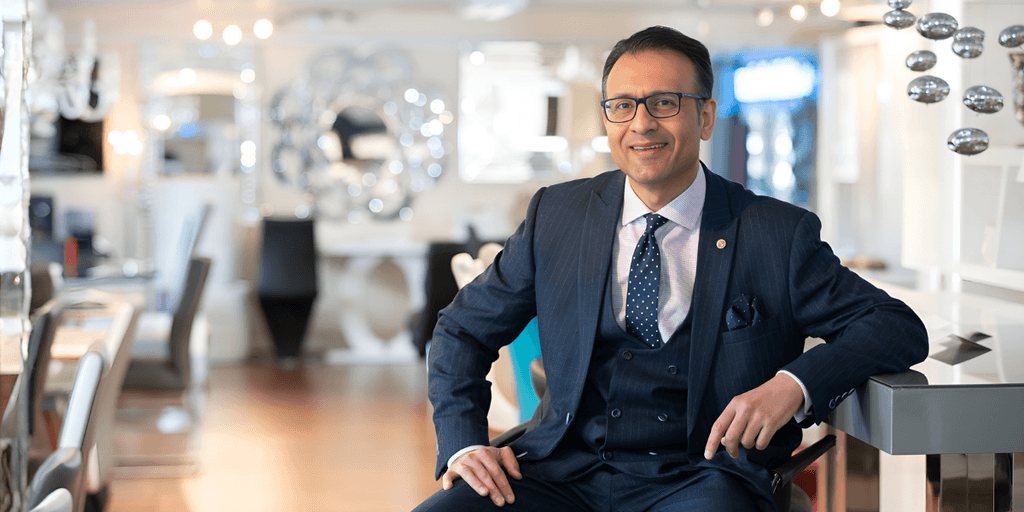 Asad Shamim, CEO of Furniture in Fashion, showcasing modern, affordable furniture in a stylish, customer-focused showroom environment.