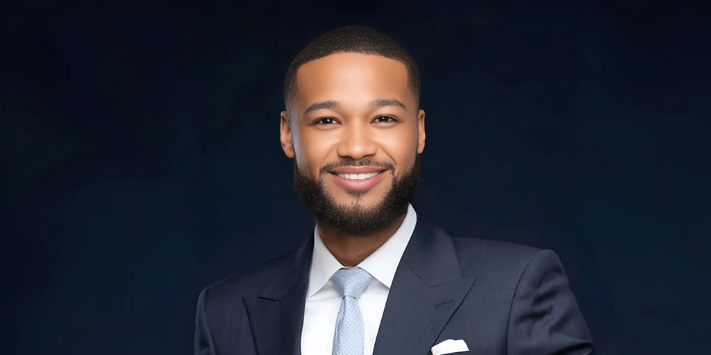 Demetrius McCloud, founder of The McCloud Firm, dressed in a sharp suit, smiling confidently. He embodies the firm's "Legal Sniper" philosophy, providing precise and client-focused legal services across personal injury, business advisory, and corporate law.