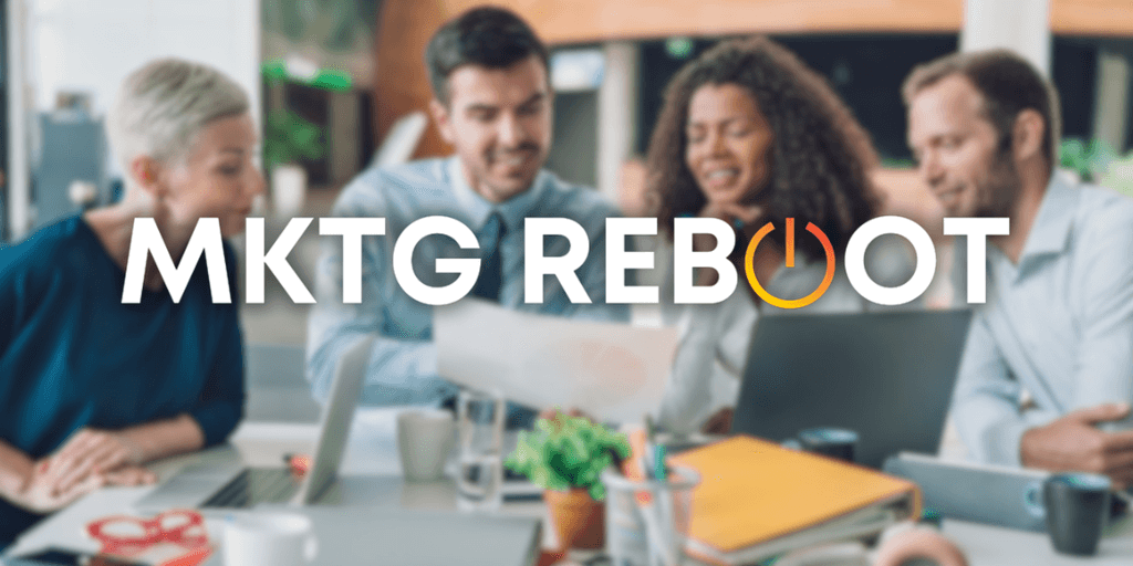 A diverse group of professionals collaborates around a table, discussing strategies to optimize marketing efforts, reflecting MKTG Reboot’s focus on structured, growth-driven marketing solutions.