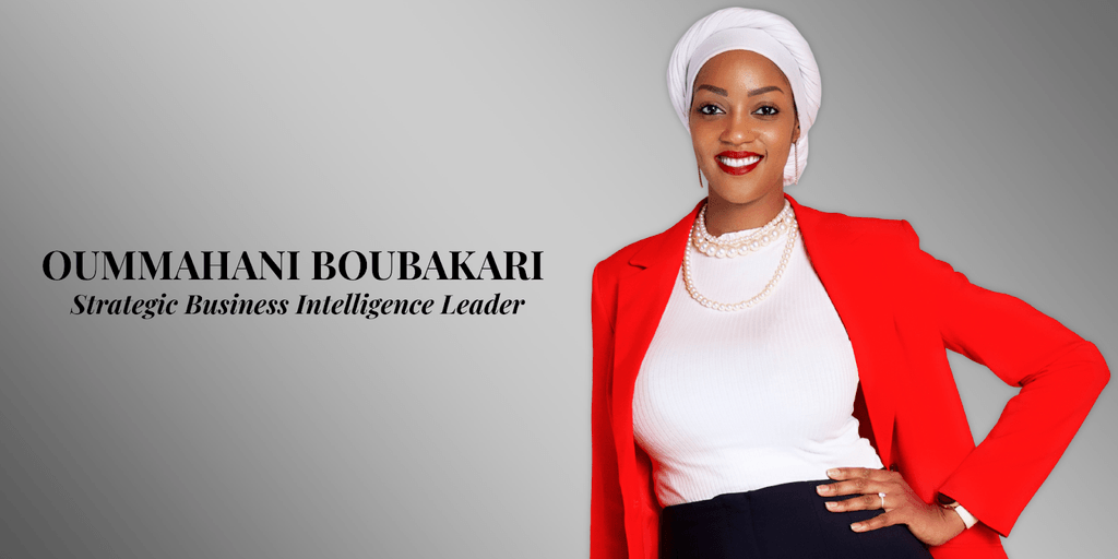 Portrait of Oummhani Boubakari, a Strategic Business Intelligence Leader, wearing a red blazer, white top, and pearl necklace.