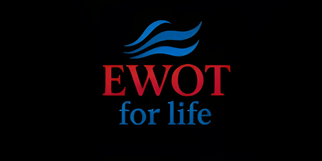 The logo of EWOT for Life, featuring the bold red and blue text 'EWOT' with the tagline 'for life' in blue. The design includes flowing wave-like elements in blue, symbolizing the breath-enhancing technology associated with the brand.