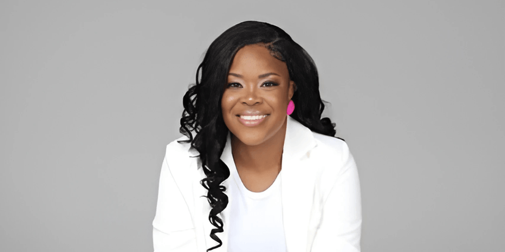 Annika V. Brown, CEO of New Dimension Consulting, smiles confidently after completing her 365-day live-streaming challenge.