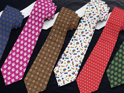 Colorful patterned ties arranged in a row on a dark background