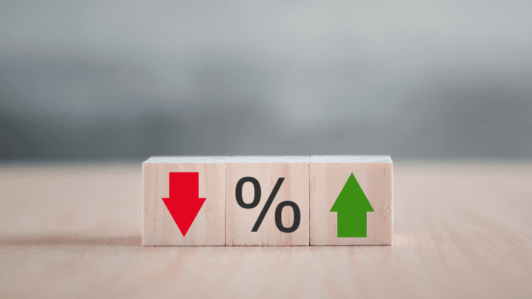 Wooden blocks displaying a red down arrow, percentage sign, and green up arrow