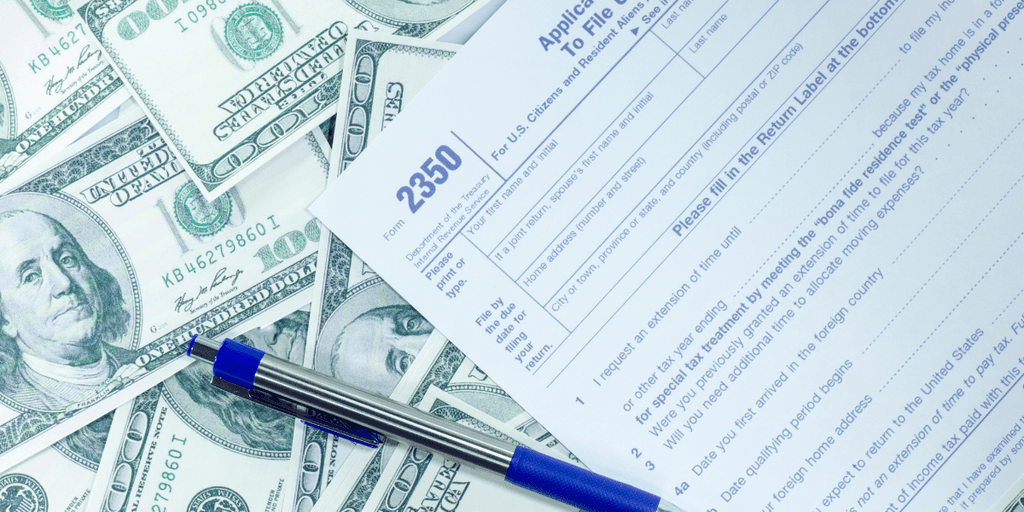 Application form 2350 surrounded by U.S. dollar bills and a blue pen
