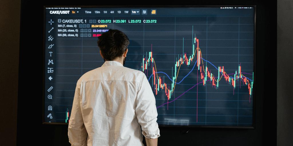 Person analyzing cryptocurrency charts on a digital screen in a modern setting