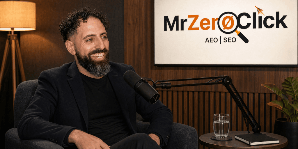 Man with curly hair and beard smiling during a podcast recording in a studio