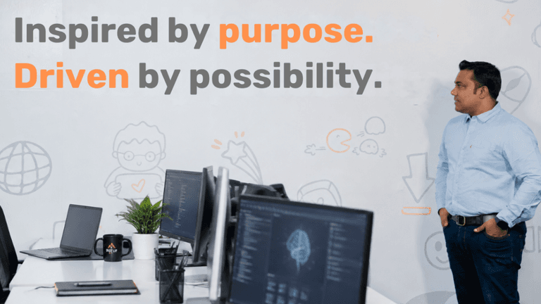 A man stands in an office, reflecting on a motivational poster about purpose and possibility